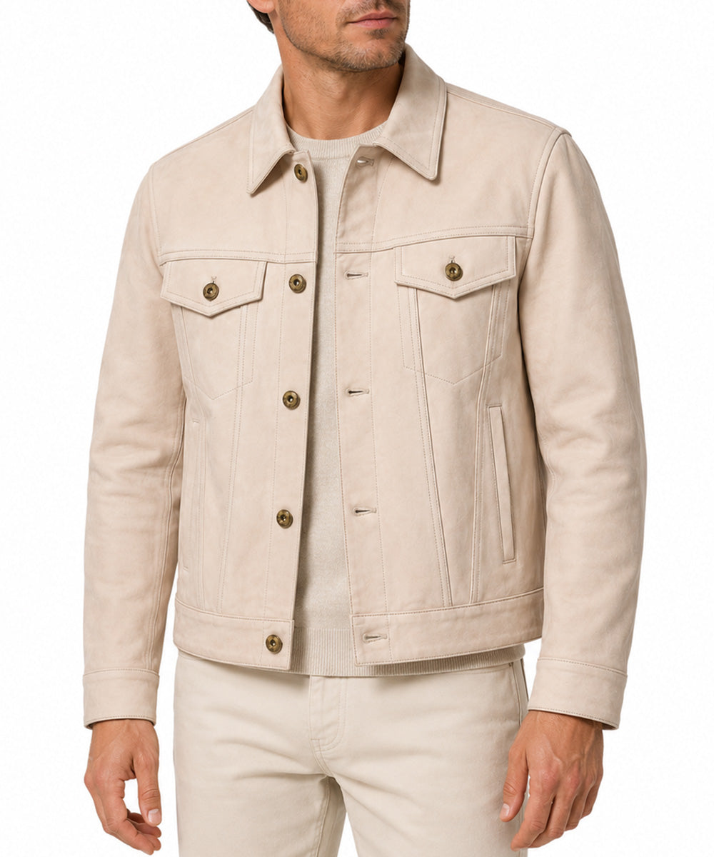 A man wearing a light beige denim jacket with brown buttons, paired with matching beige trousers, shown from the chin down on a white background.