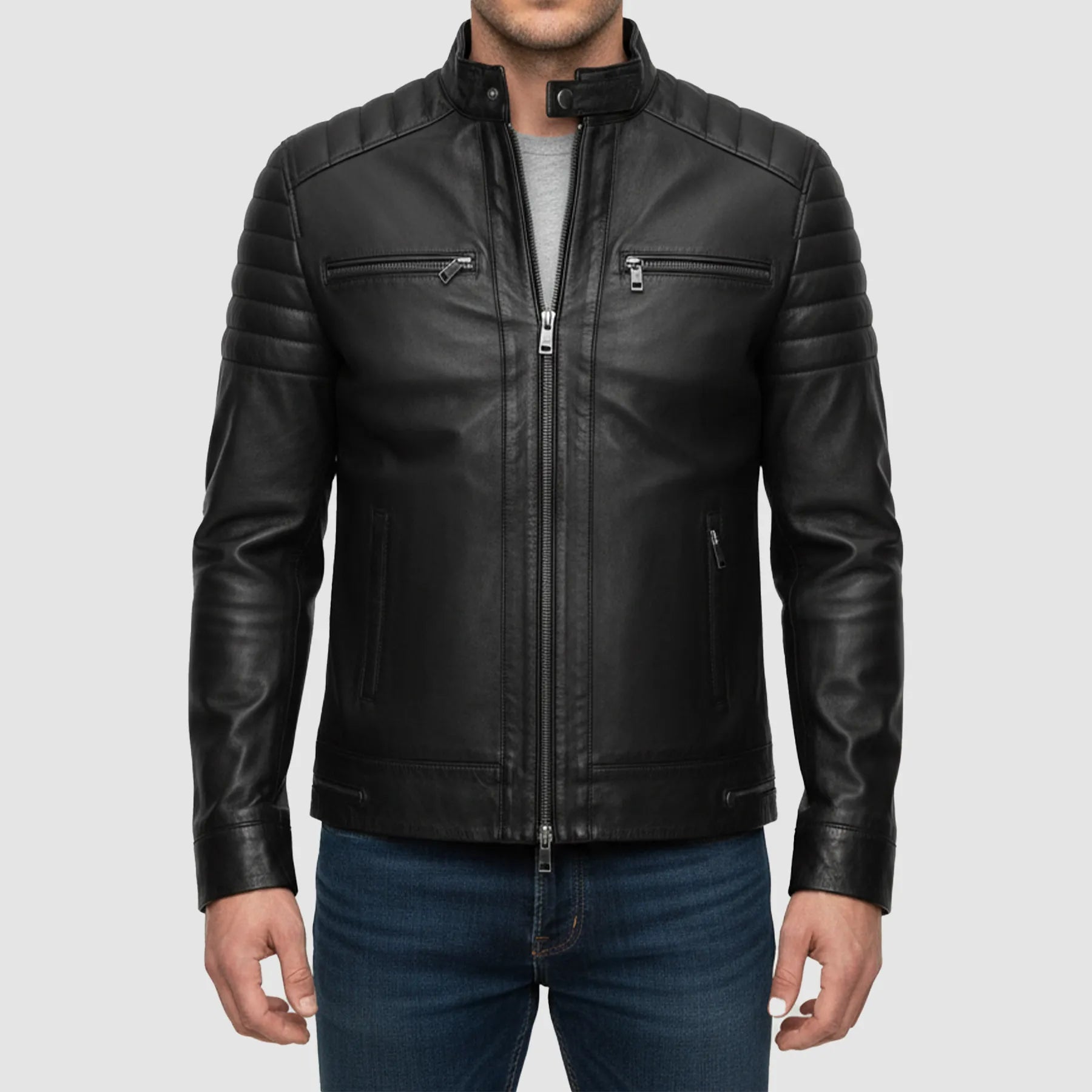 Black leather jacket worn by a person on a light gray background