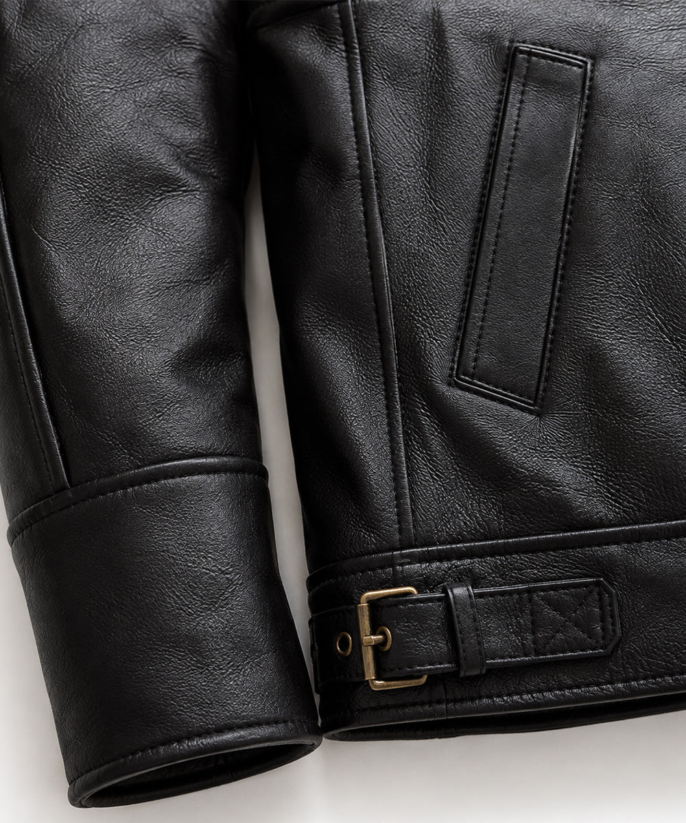 Detail of banded leather cuff, welt hand pocket and brass buckle side adjuster