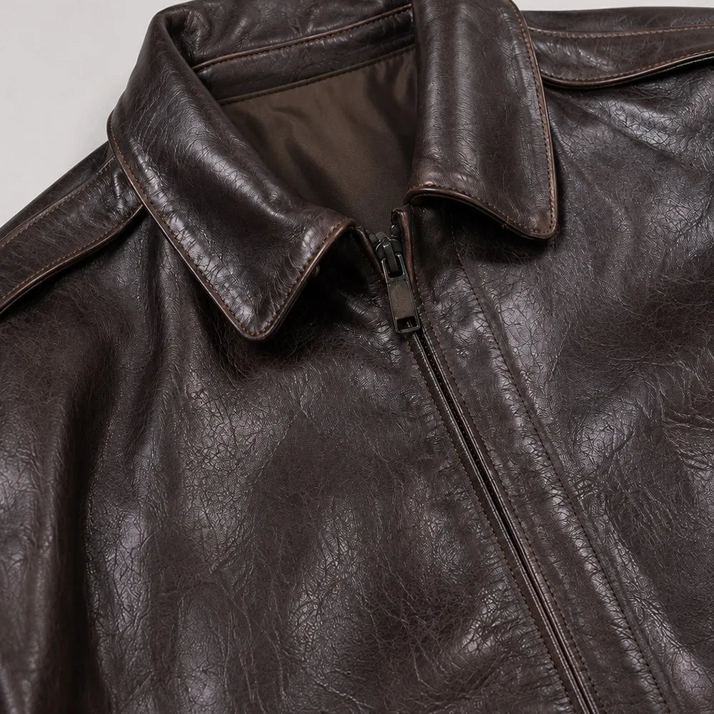 Vintage A-2 leather flight jacket for men with a shirt collar, rib-knit waistband, and authentic aviation-inspired styling.