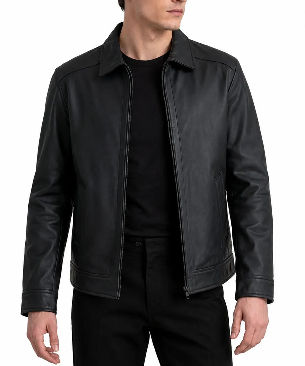A man wearing a black leather jacket over a black t-shirt and black pants, shown from the neck down against a plain white background.
