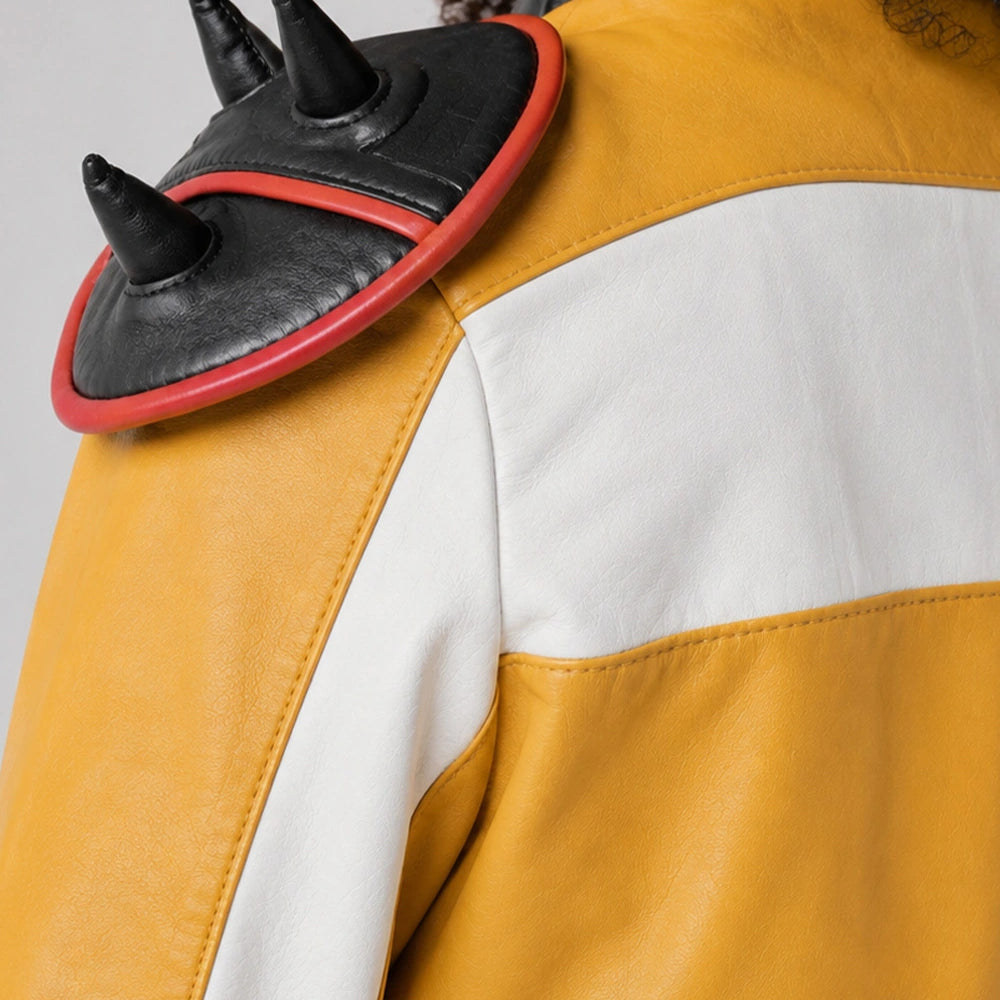 Close-up of the Rumi Kpop Demon Hunters Jacket showing embroidered graphic patches, premium stitching, and yellow leather finish.