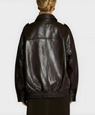 Person wearing a black leather jacket on a white background