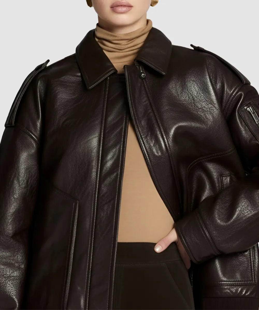 Brown leather bomber jacket made with brown sheepskin worn by a model on a plain background