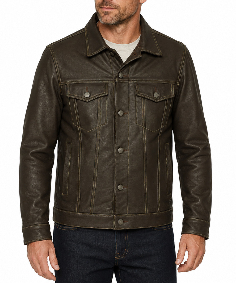 A man wearing a dark brown leather jacket with a button-up front, chest flap pockets, and contrast stitching, paired with a light gray t-shirt and dark blue jeans, against a plain white background.