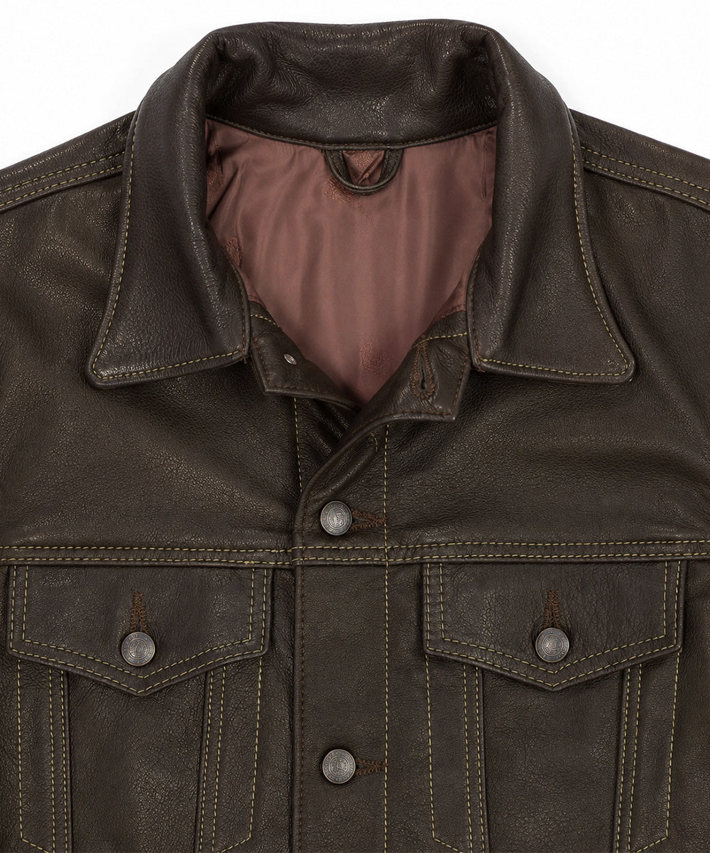 Close-up of a dark brown leather jacket showing the collar, buttoned front, and two chest pockets with silver-toned snap buttons against a plain white background.