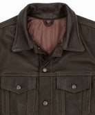 Close-up of a dark brown leather jacket showing the collar, buttoned front, and two chest pockets with silver-toned snap buttons against a plain white background.
