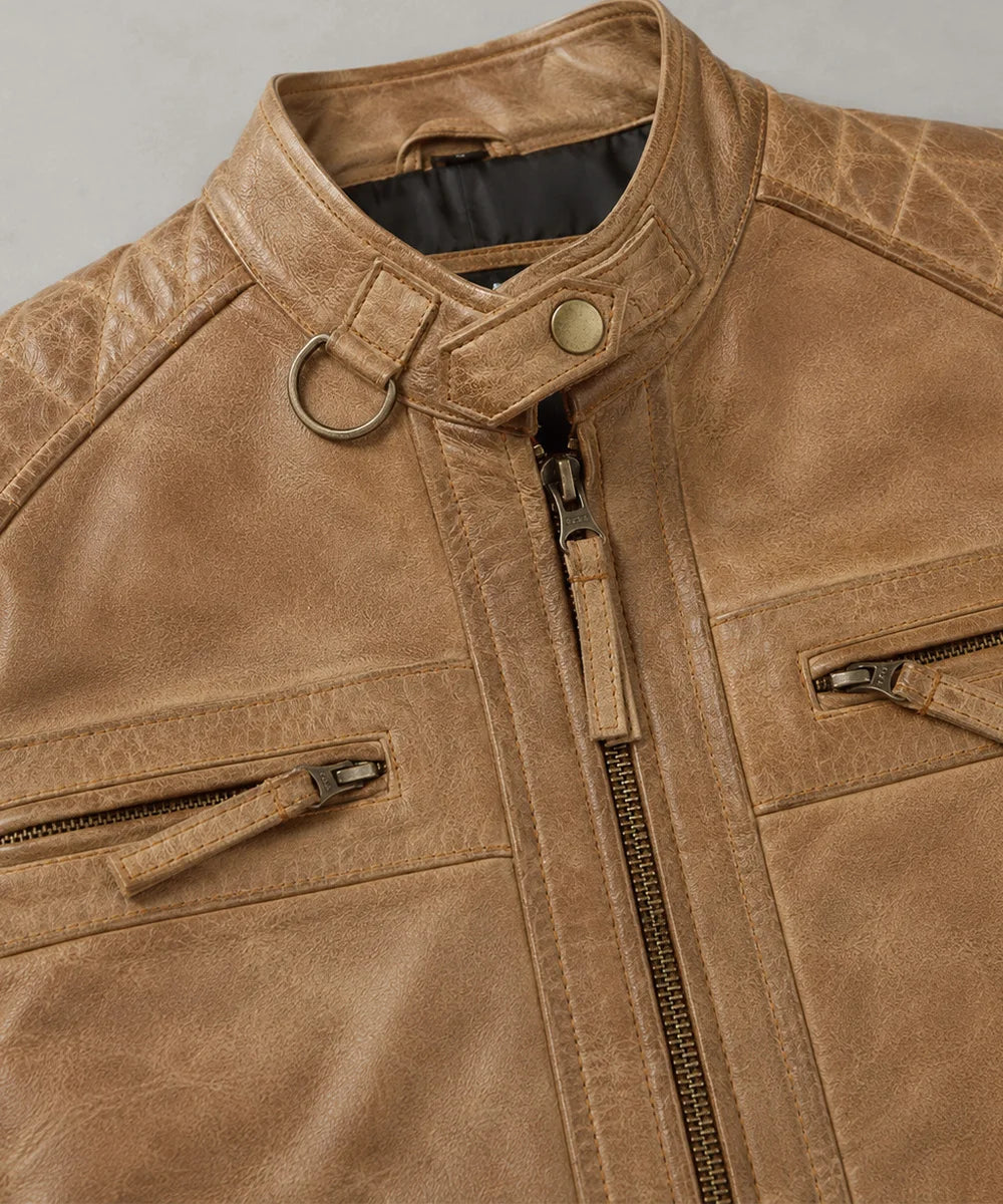 Close-up of camel leather jacket showing premium texture, zipper details, functional pockets, and quality craftsmanship.