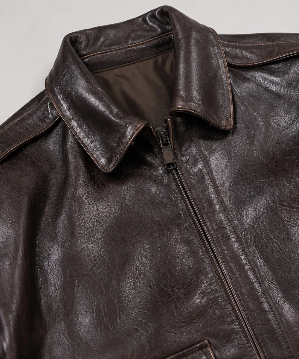 Vintage A-2 leather flight jacket for men with a shirt collar, rib-knit waistband, and authentic aviation-inspired styling.