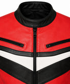Close-up of a red leather jacket with black and white chevron-style panels, black collar, and front zipper.