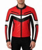 A man wearing a red, black, and white leather jacket with a chevron pattern, paired with black pants, against a plain white background.