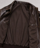 Genuine cowhide leather flight jacket in dark brown featuring a timeless A-2 bomber silhouette for everyday and outdoor wear.

