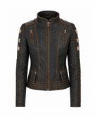 A black faux-leather biker jacket with gold-toned contrast stitching, decorative gold star patches on the sleeves, and zippered pockets, shown against a plain white background.