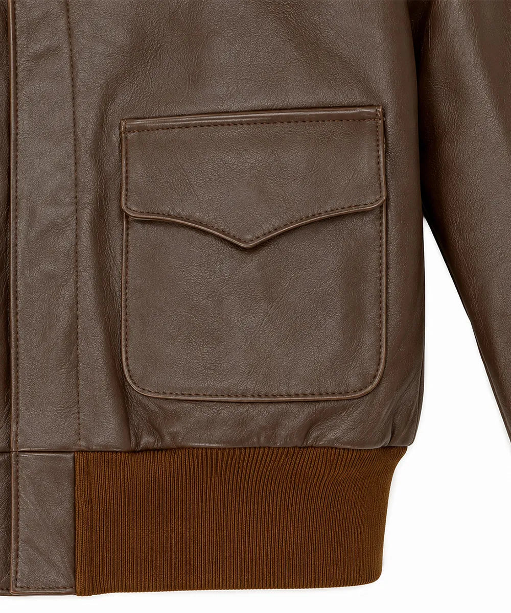 Close-up of a brown leather jacket showing a flap pocket and a ribbed brown knit hem against a white background.